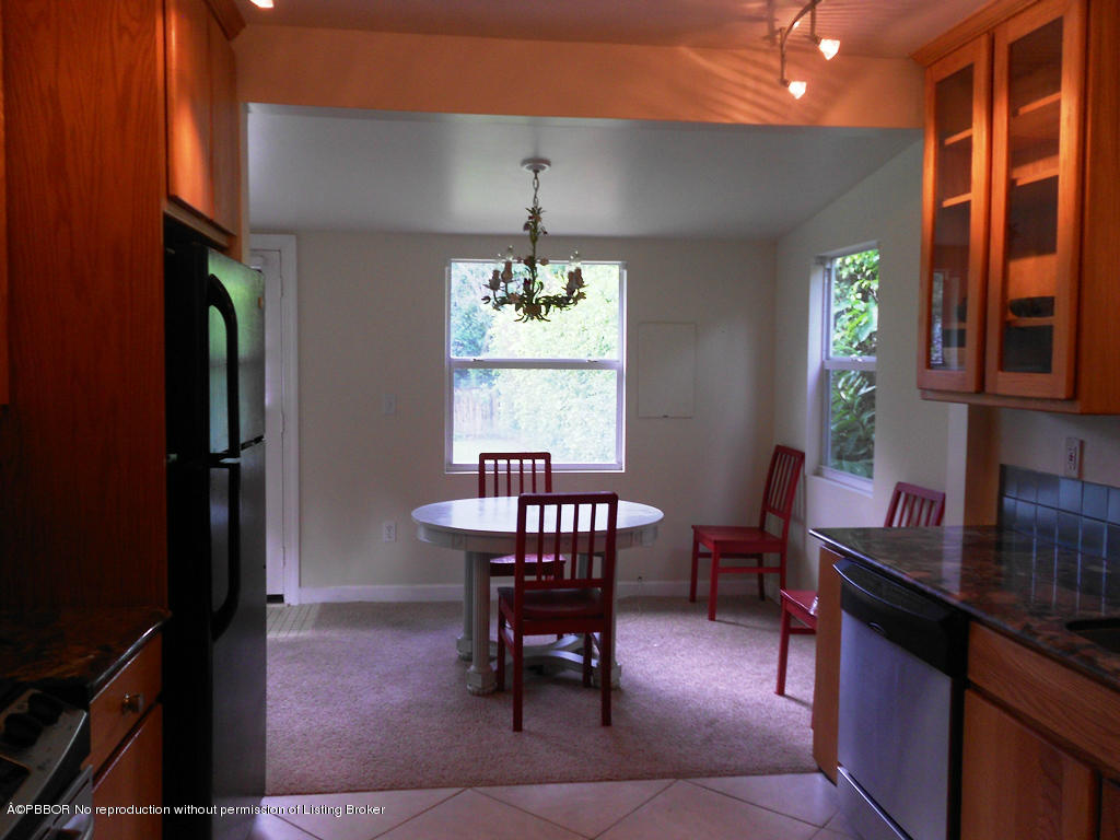 314 Westminster Road West Palm Beach, FL 33405 - Photo 6 of 9 a dining room with furniture a chandelier and window