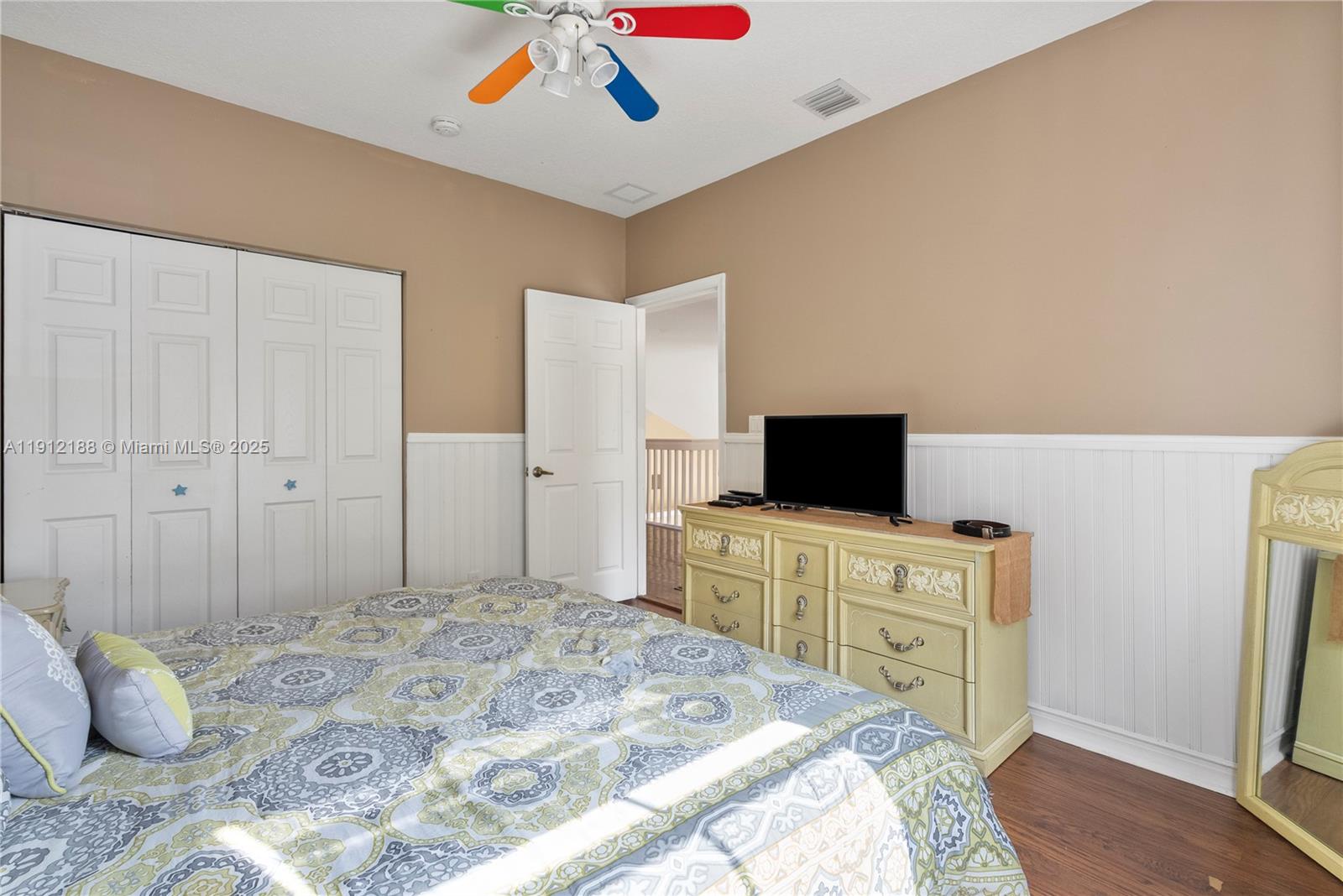 2795 Southeast Stonebriar Way Stuart, FL 34997 - Photo 11 of 54 a bedroom with a bed and a television