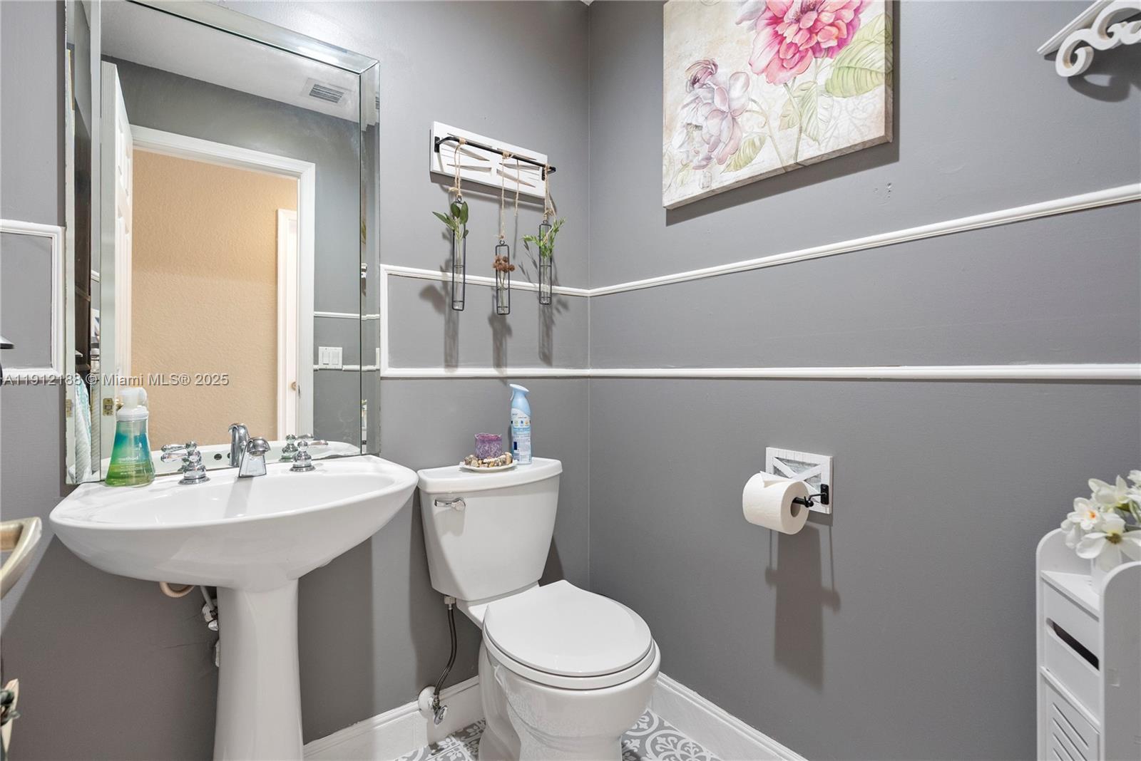 2795 Southeast Stonebriar Way Stuart, FL 34997 - Photo 12 of 54 a bathroom with a toilet a sink and mirror