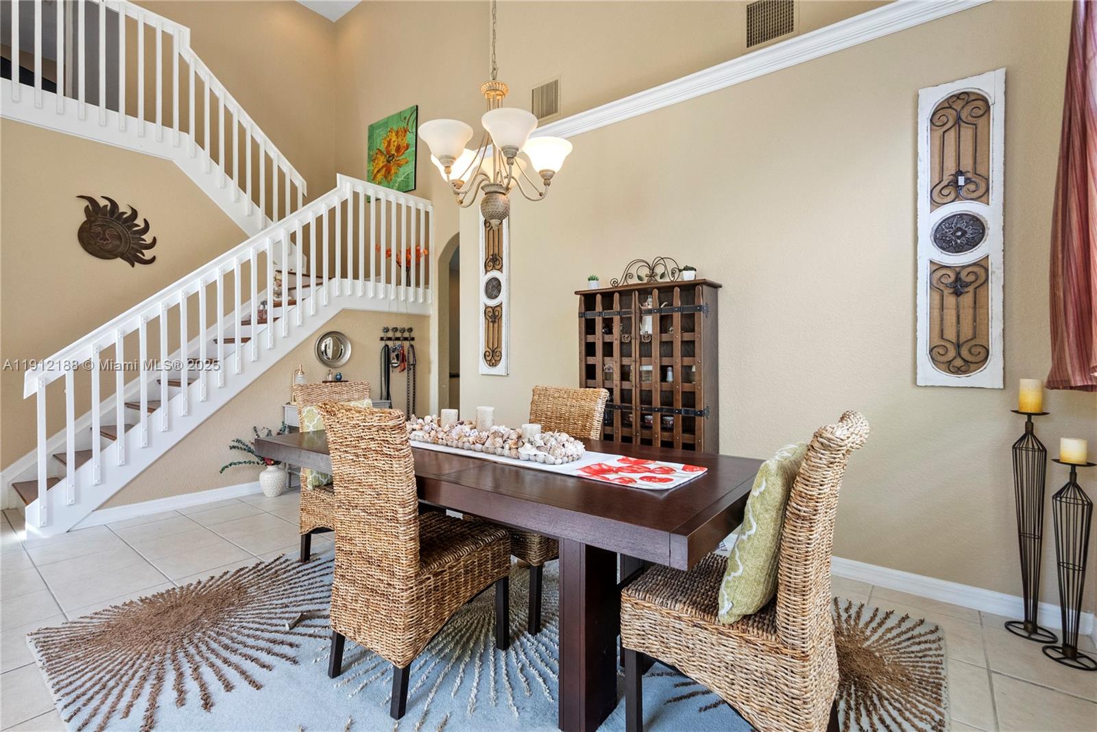 2795 Southeast Stonebriar Way Stuart, FL 34997 - Photo 16 of 54 a view of a dining room with furniture and a chandelier