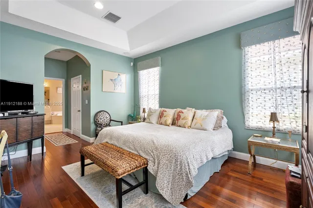 a bedroom with a bed and a flat screen tv