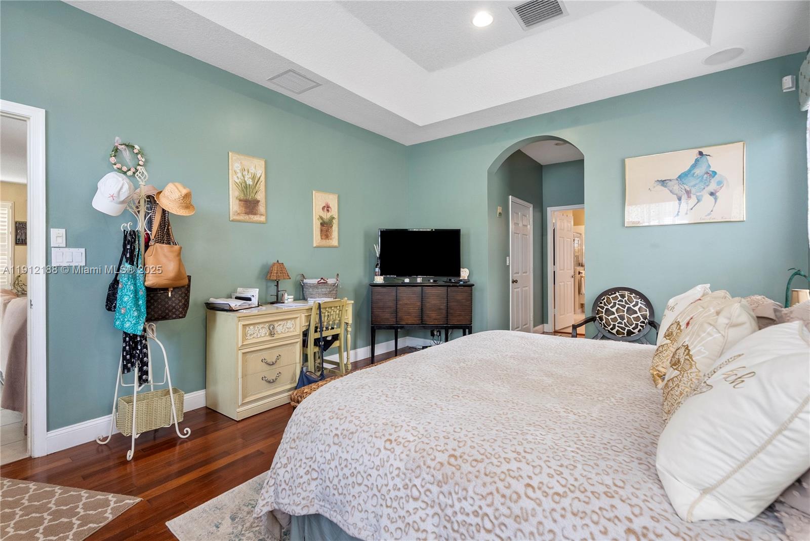 2795 Southeast Stonebriar Way Stuart, FL 34997 - Photo 20 of 54 a bedroom with a bed and a flat screen tv