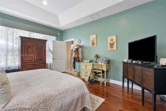 a bathroom with a double vanity sink mirror and bathtub