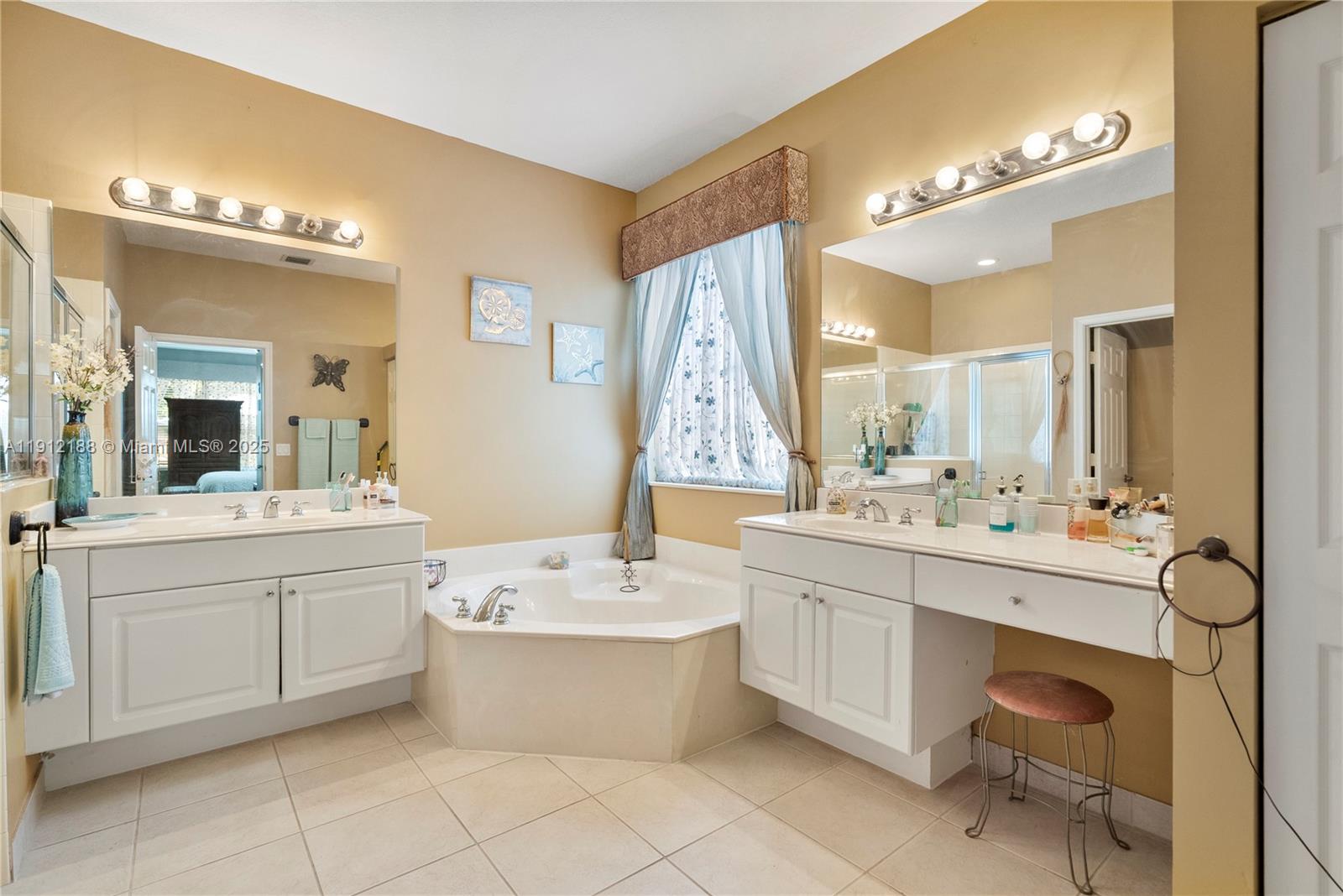 2795 Southeast Stonebriar Way Stuart, FL 34997 - Photo 22 of 54 a bathroom with a double vanity sink mirror and bathtub