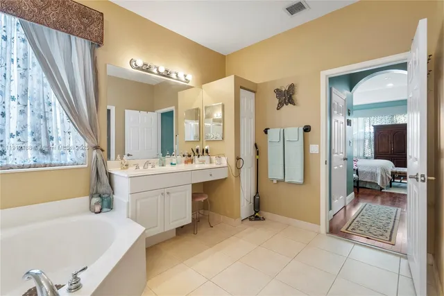 a kitchen with stainless steel appliances granite countertop a refrigerator oven a sink dishwasher and a refrigerator with wooden cabinets