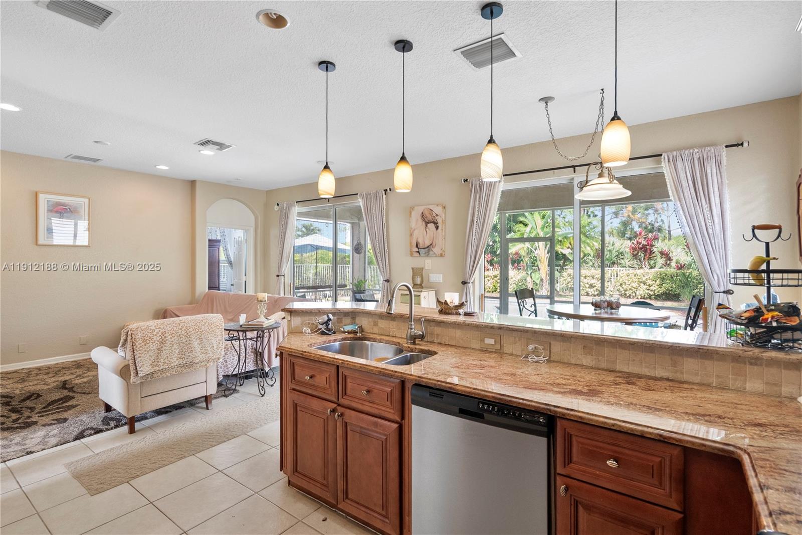 2795 Southeast Stonebriar Way Stuart, FL 34997 - Photo 29 of 54 a open kitchen with a sink a stove and a wooden floors