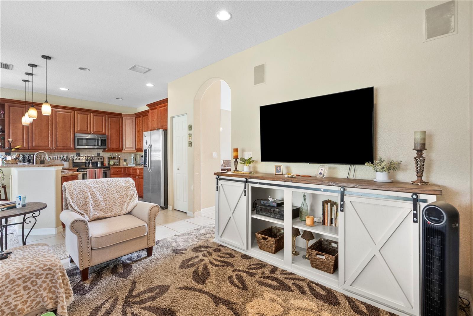 2795 Southeast Stonebriar Way Stuart, FL 34997 - Photo 33 of 54 a living room with furniture and a flat screen tv