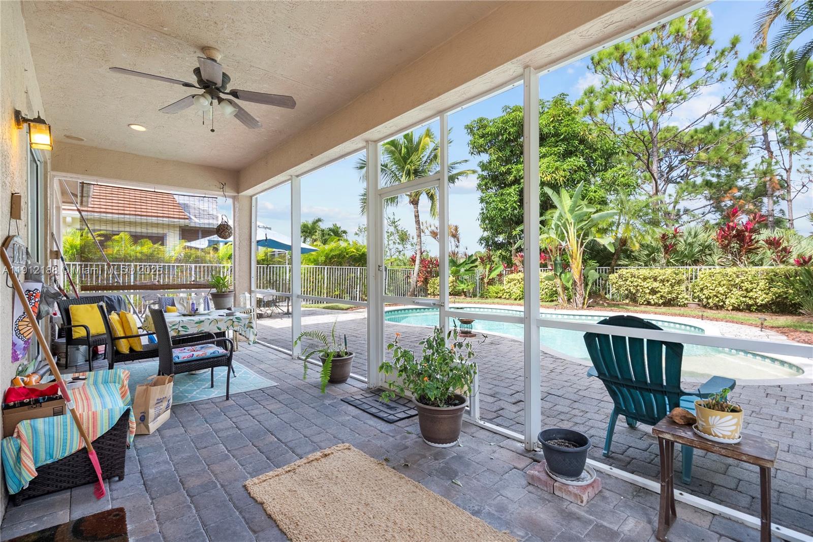 2795 Southeast Stonebriar Way Stuart, FL 34997 - Photo 36 of 54 a living room with patio furniture and a potted plant