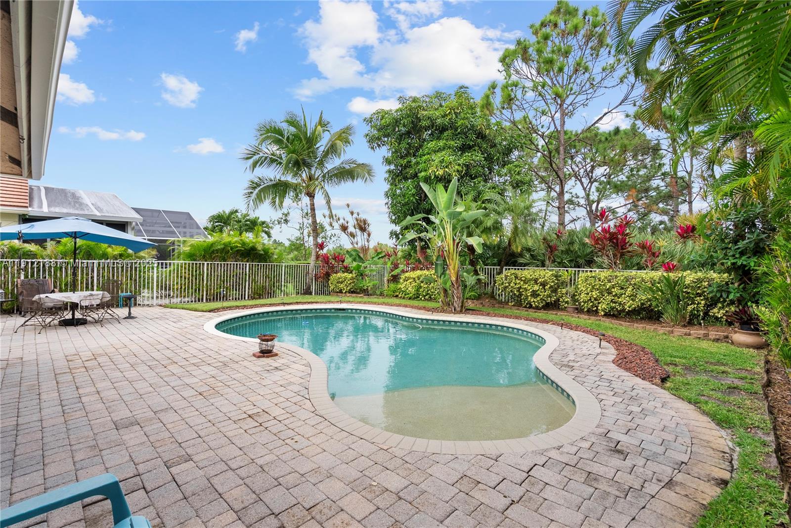 2795 Southeast Stonebriar Way Stuart, FL 34997 - Photo 38 of 54 a view of a swimming pool with a lounge chairs in the patio