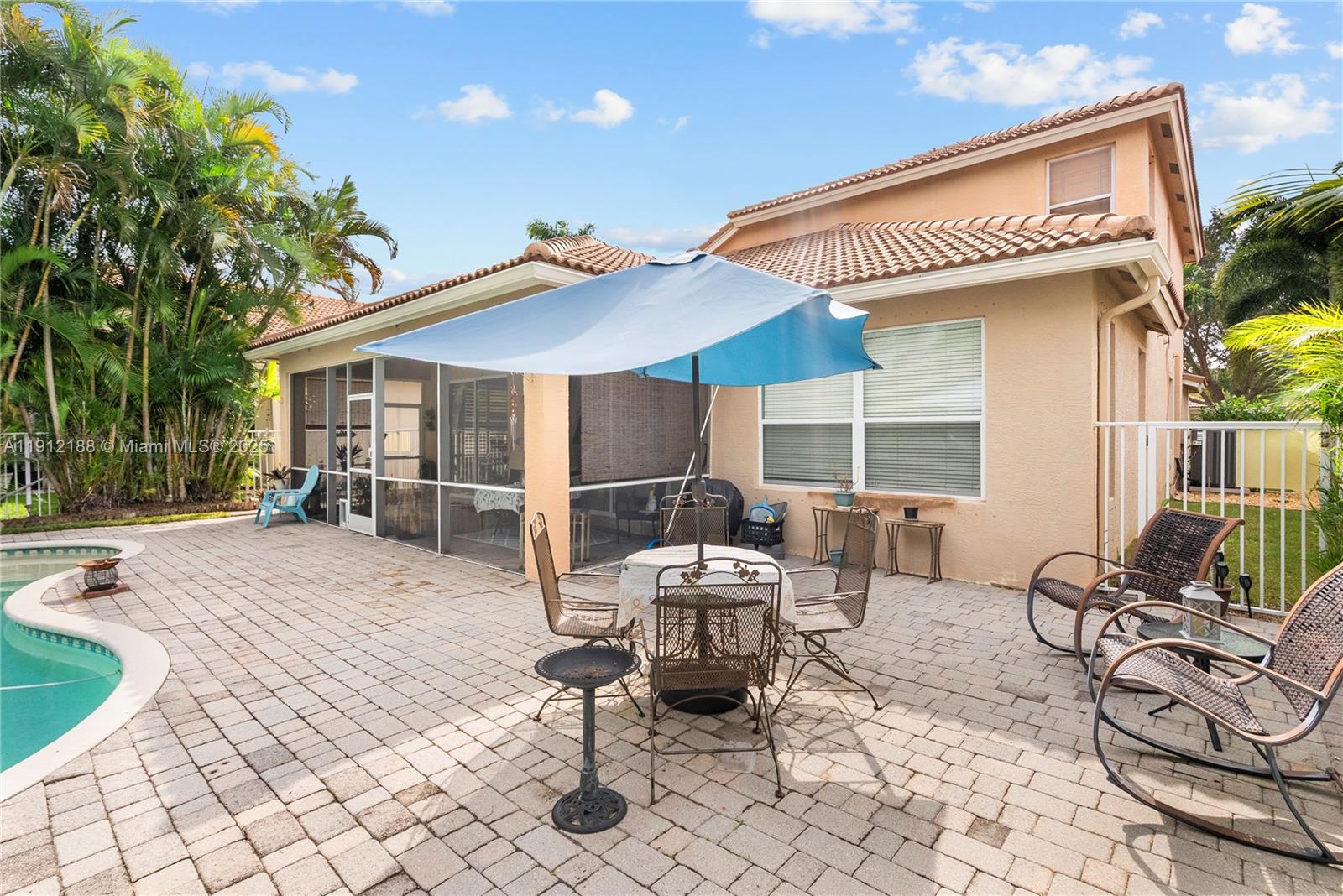 2795 Southeast Stonebriar Way Stuart, FL 34997 - Photo 41 of 54 a patio with a table and chairs and potted plants