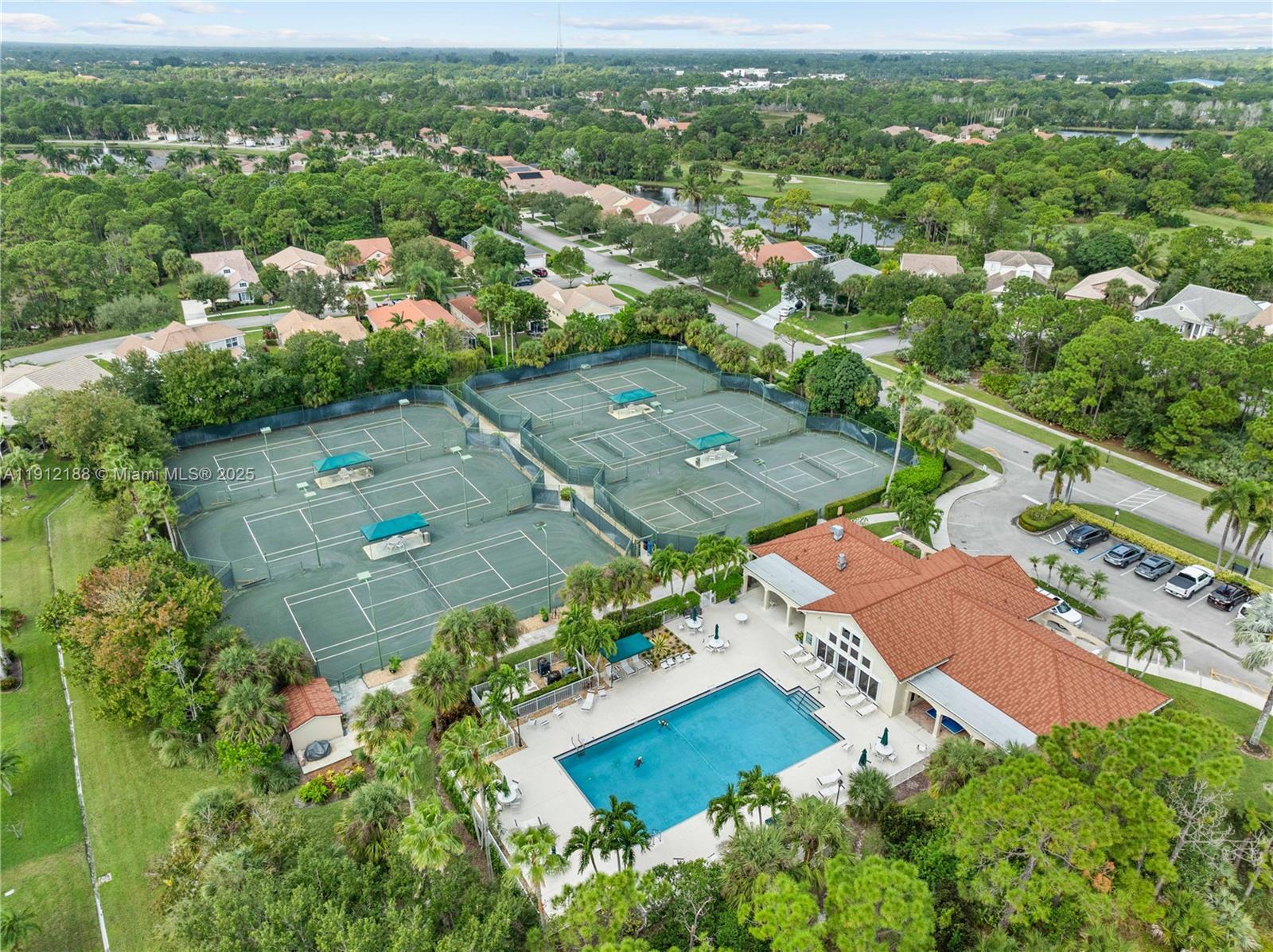 2795 Southeast Stonebriar Way Stuart, FL 34997 - Photo 43 of 54 an aerial view of residential houses with outdoor space and trees