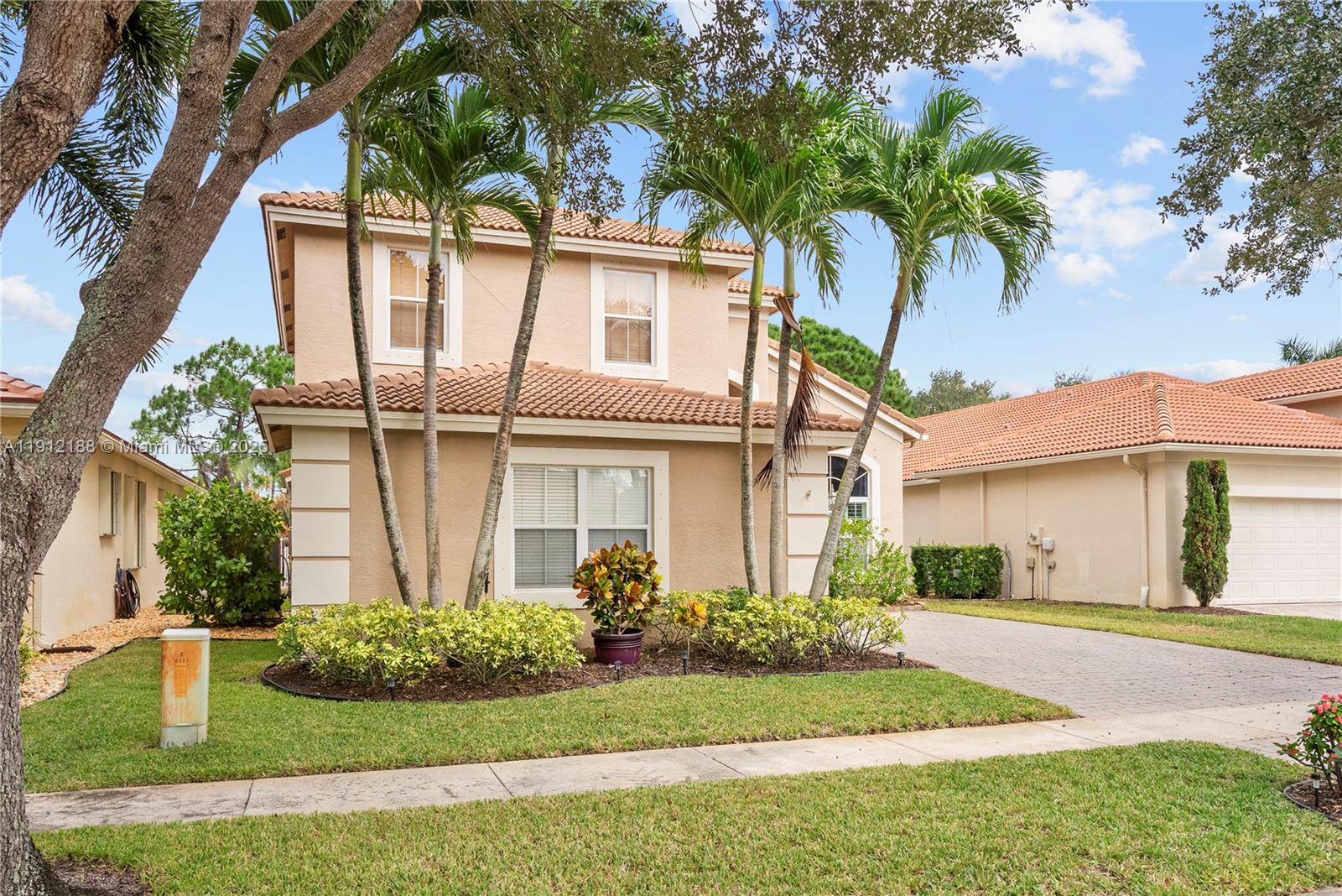 2795 Southeast Stonebriar Way Stuart, FL 34997 - Photo 44 of 54 a front view of a house with a garden