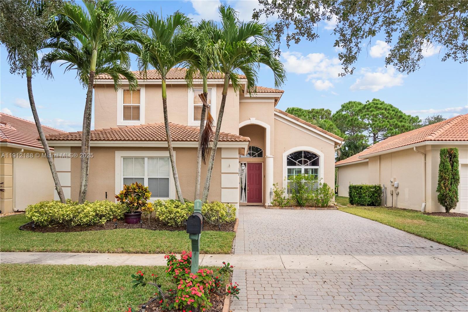 2795 Southeast Stonebriar Way Stuart, FL 34997 - Photo 45 of 54 a front view of a house with a garden
