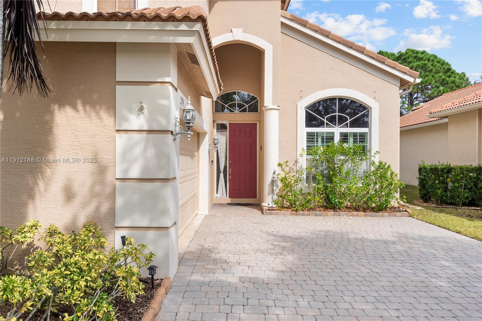 2795 Southeast Stonebriar Way Stuart, FL 34997 - Photo 46 of 54 a front view of a house with garden