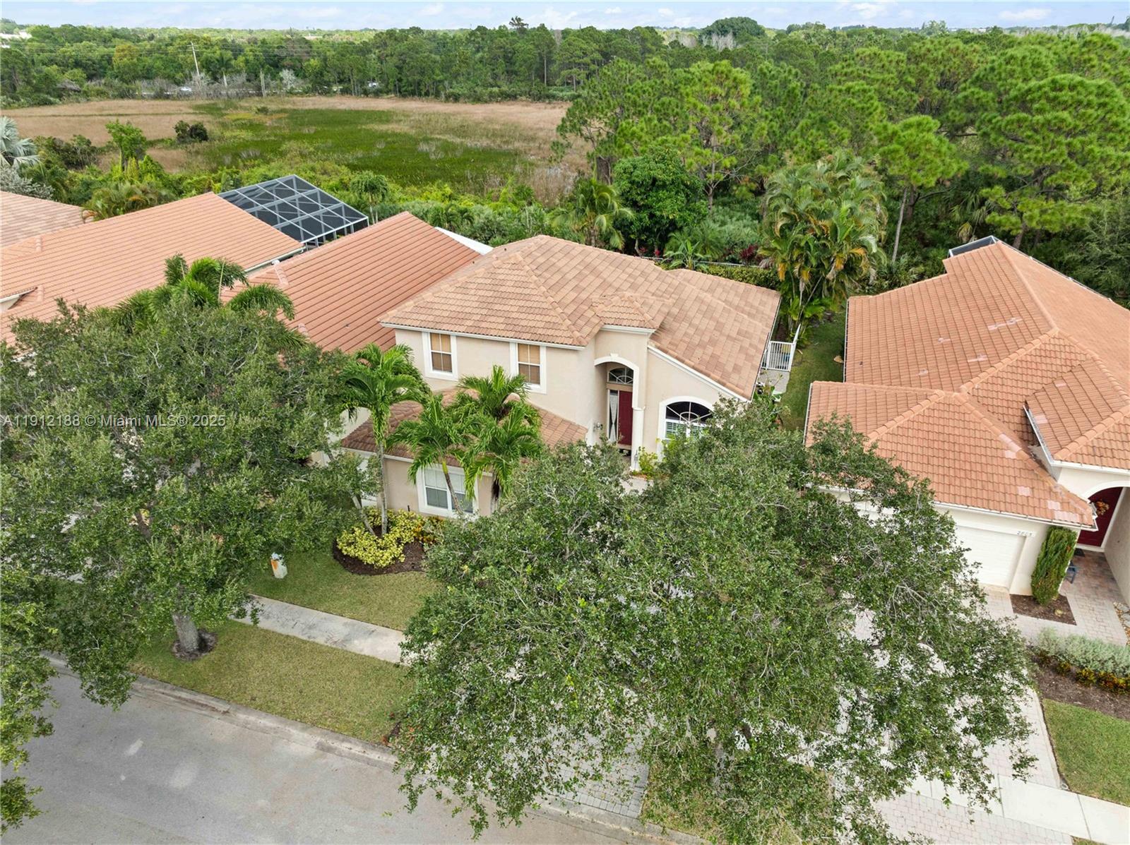 2795 Southeast Stonebriar Way Stuart, FL 34997 - Photo 49 of 54 an aerial view of a house with garden space and lake view