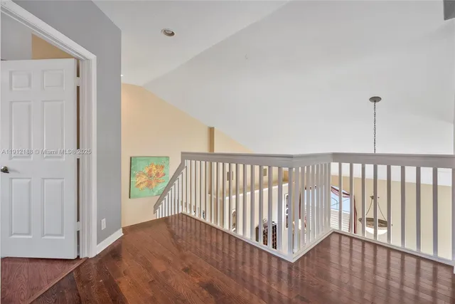 a view of hallway with wooden floor