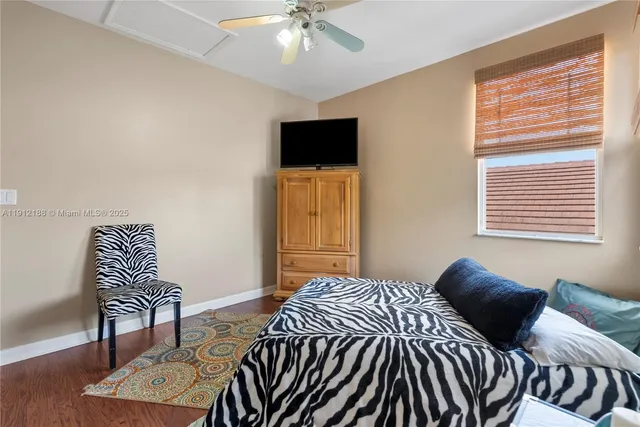 a bedroom with a bed and flat screen tv