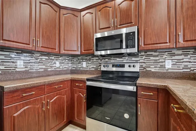 a kitchen with a sink and a refrigerator