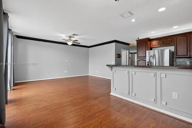 a view of a ceiling fan with wooden floor
