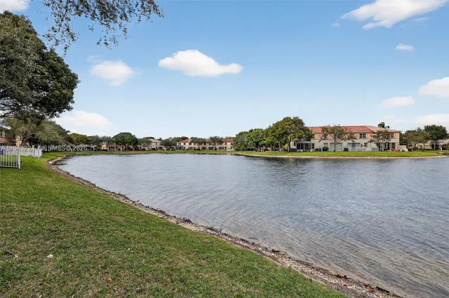 a view of a lake and trees in the background