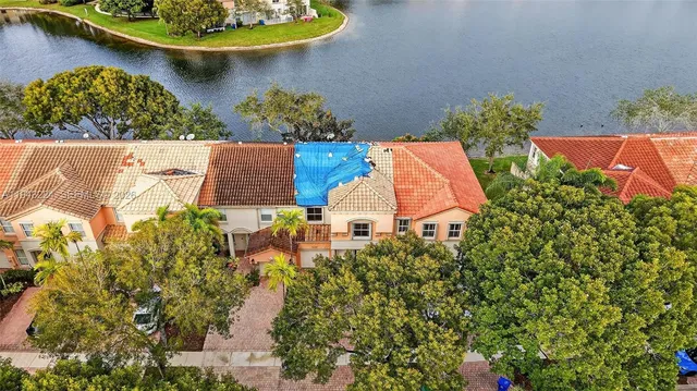 an aerial view of a house with a lake view