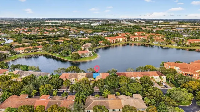 an aerial view of a city with lots of residential buildings lake and ocean view