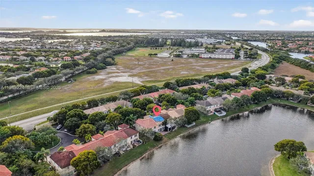 an aerial view of residential building and lake