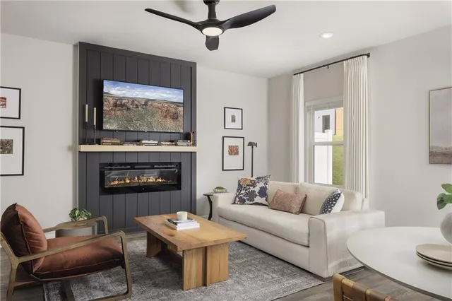 a living room with furniture a fireplace and a flat screen tv