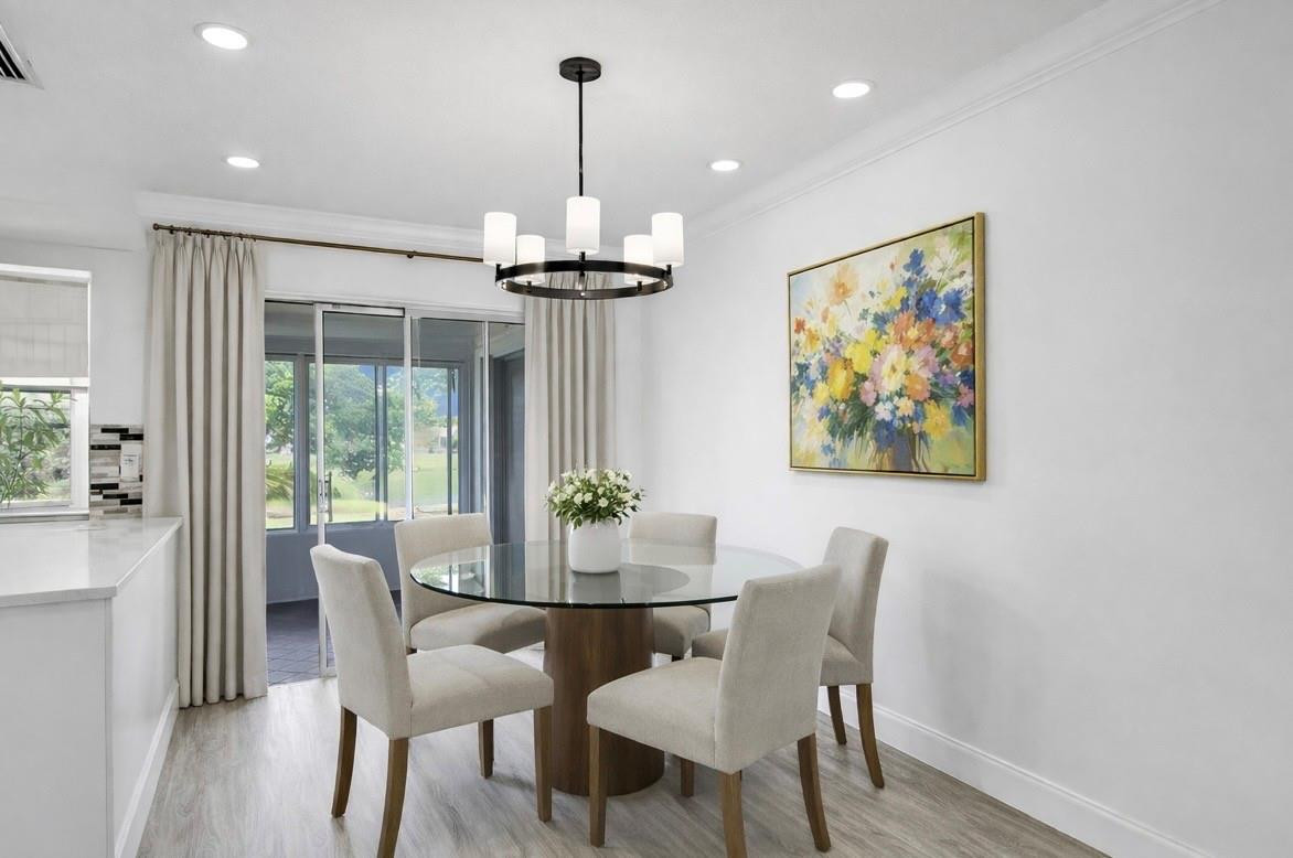 6755 Northwest 15th Street Margate, FL 33063 - Photo 5 of 11 a view of a dining room with furniture a chandelier and wooden floor