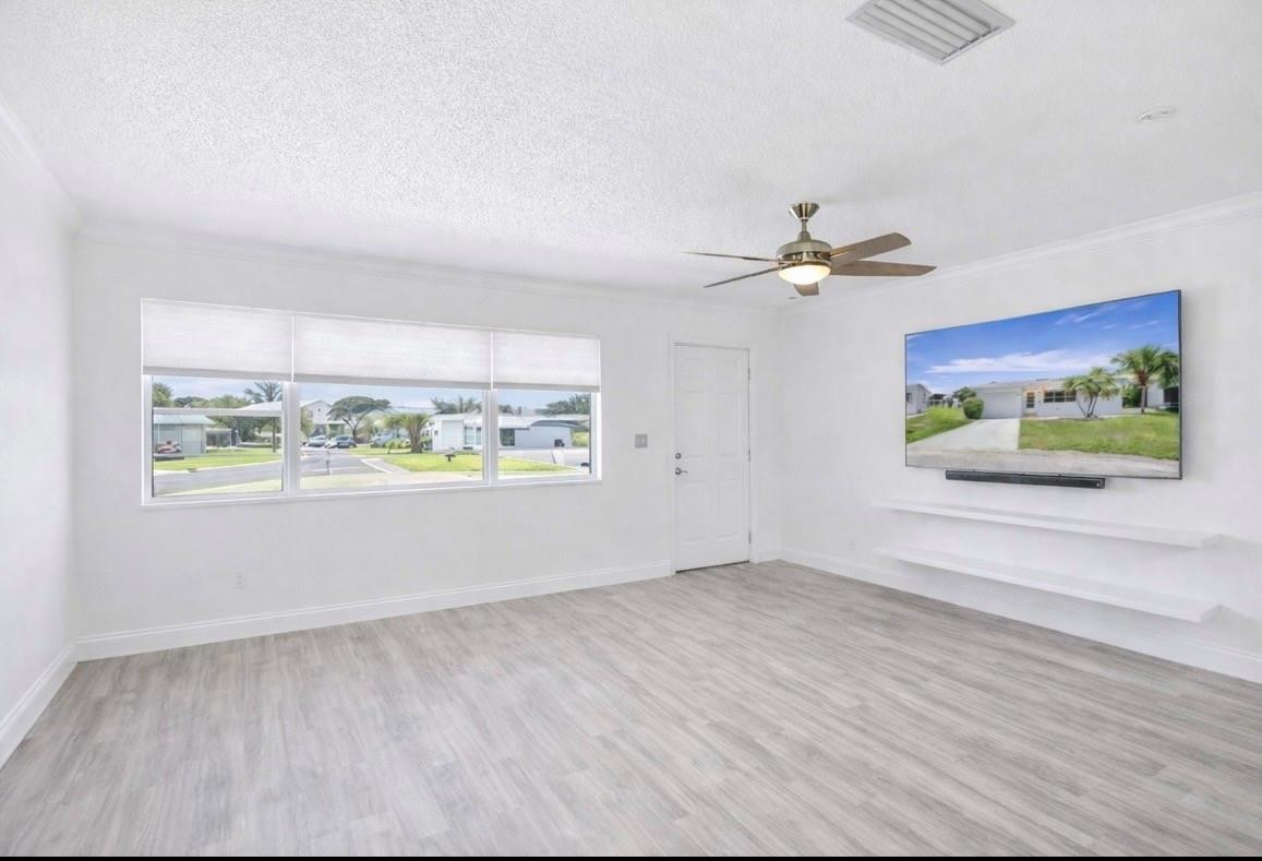 6755 Northwest 15th Street Margate, FL 33063 - Photo 9 of 11 an empty room with window and ceiling fan