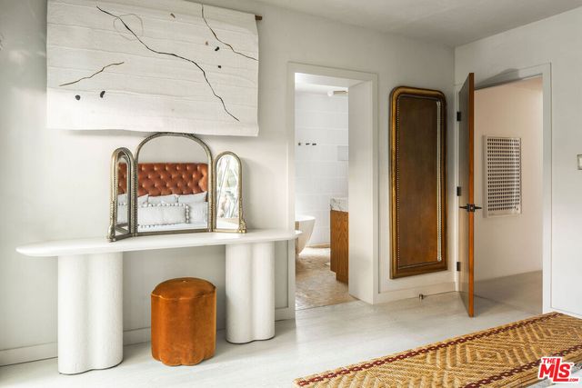a view of kitchen with furniture and refrigerator