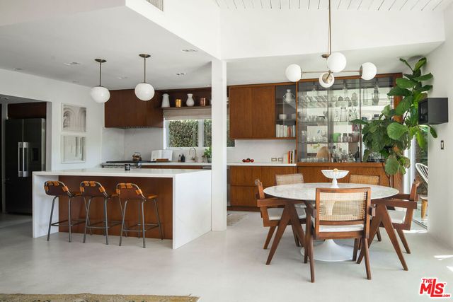 a kitchen with a table and chairs in it
