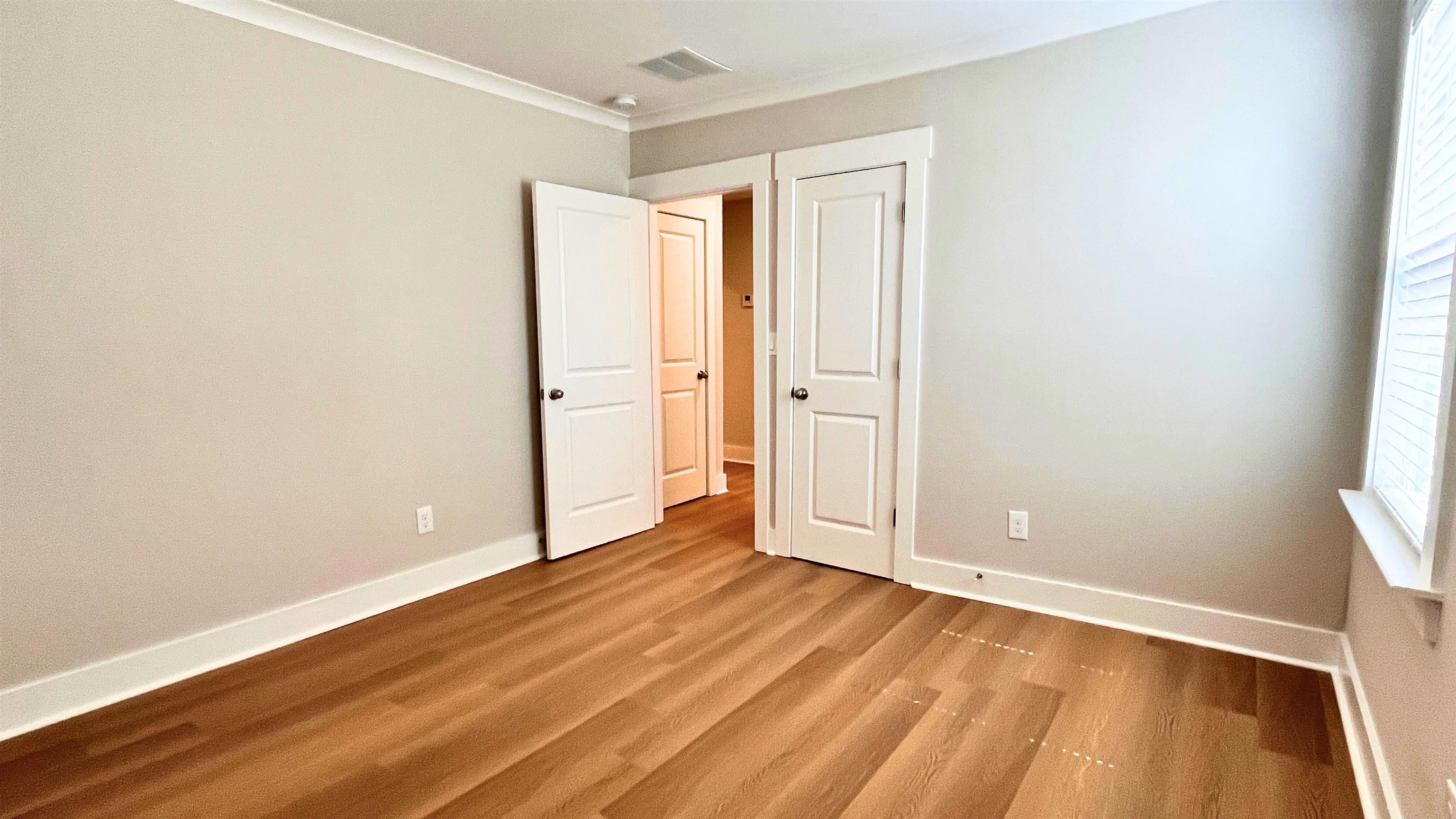 406 South Fenwick Road Memphis, TN 38111 - Photo 18 of 23 an empty room with wooden floor and a window
