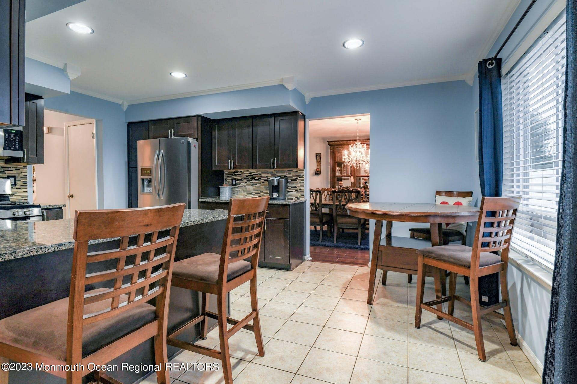 98 Starlight Road Howell, NJ 07731 - Photo 11 of 31 a dining room with furniture and a kitchen view