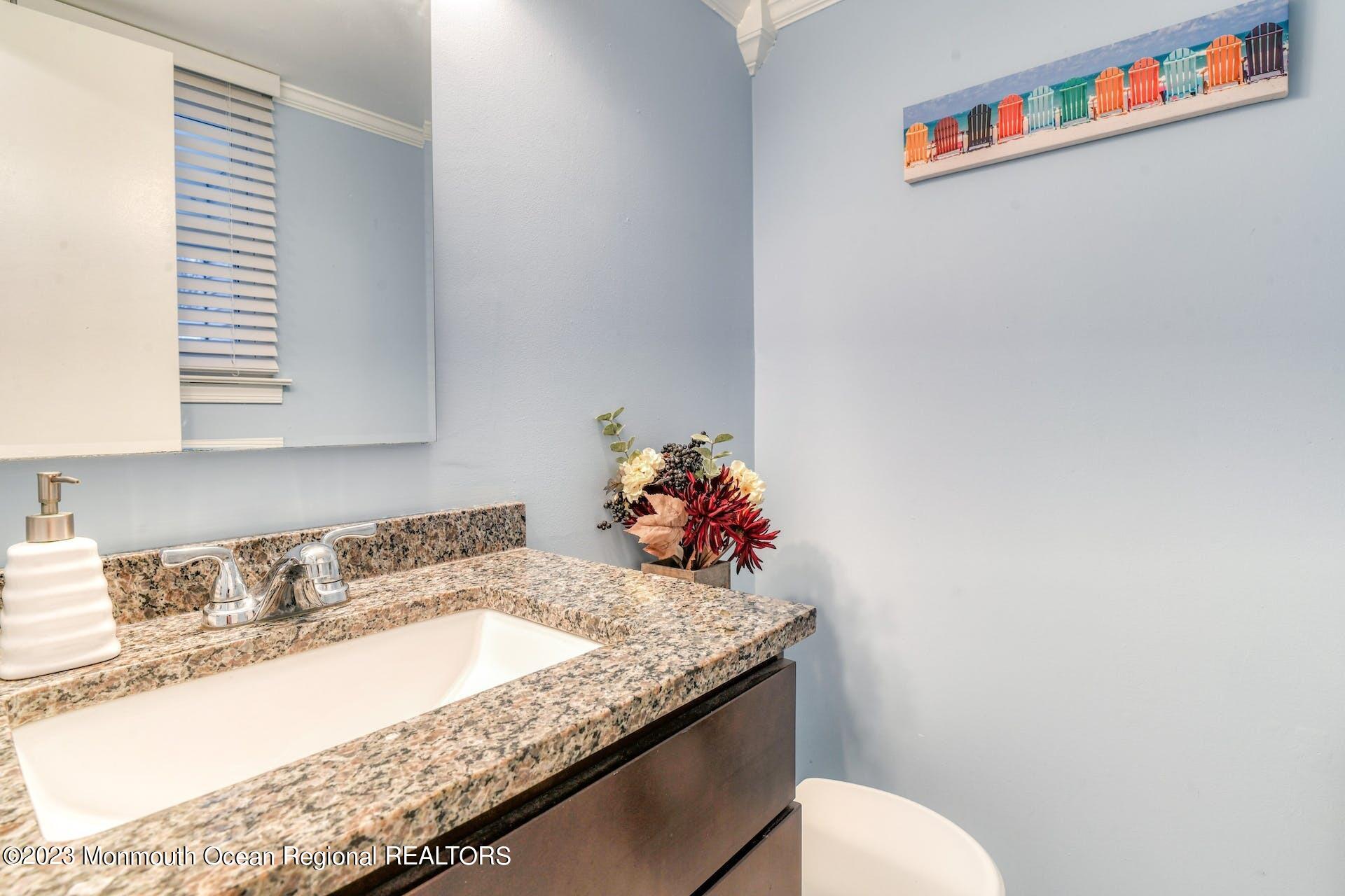 98 Starlight Road Howell, NJ 07731 - Photo 24 of 31 a bathroom with a granite countertop sink and a mirror