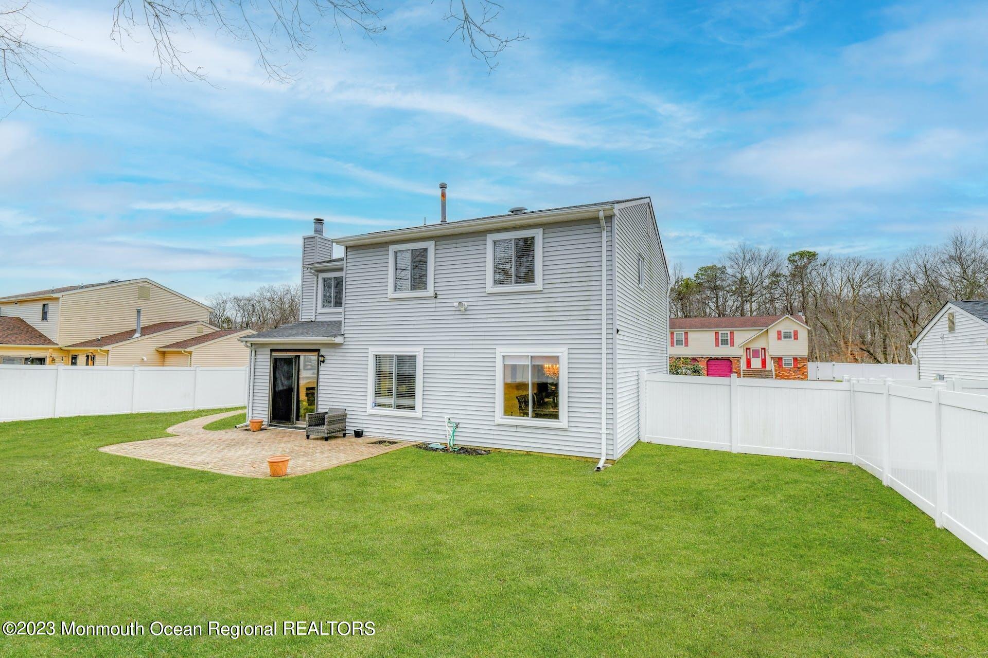 98 Starlight Road Howell, NJ 07731 - Photo 29 of 31 a front view of a house with a garden and yard