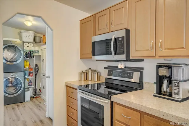 a kitchen with stainless steel appliances granite countertop a stove a microwave and a refrigerator