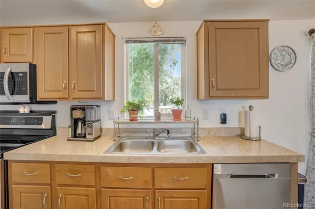 a kitchen with appliances cabinets and a sink