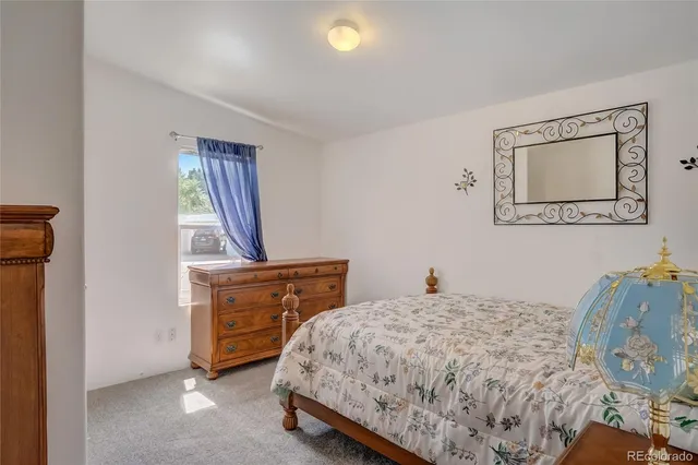 a bedroom with a bed and a dresser