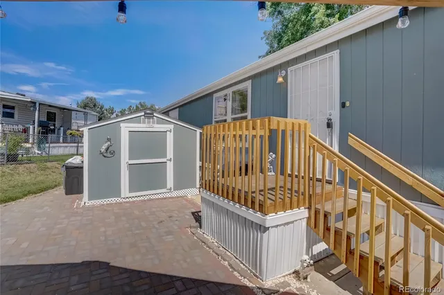 a view of a house with a yard and deck