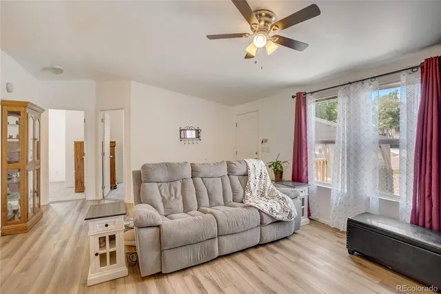 a living room with furniture and a large window