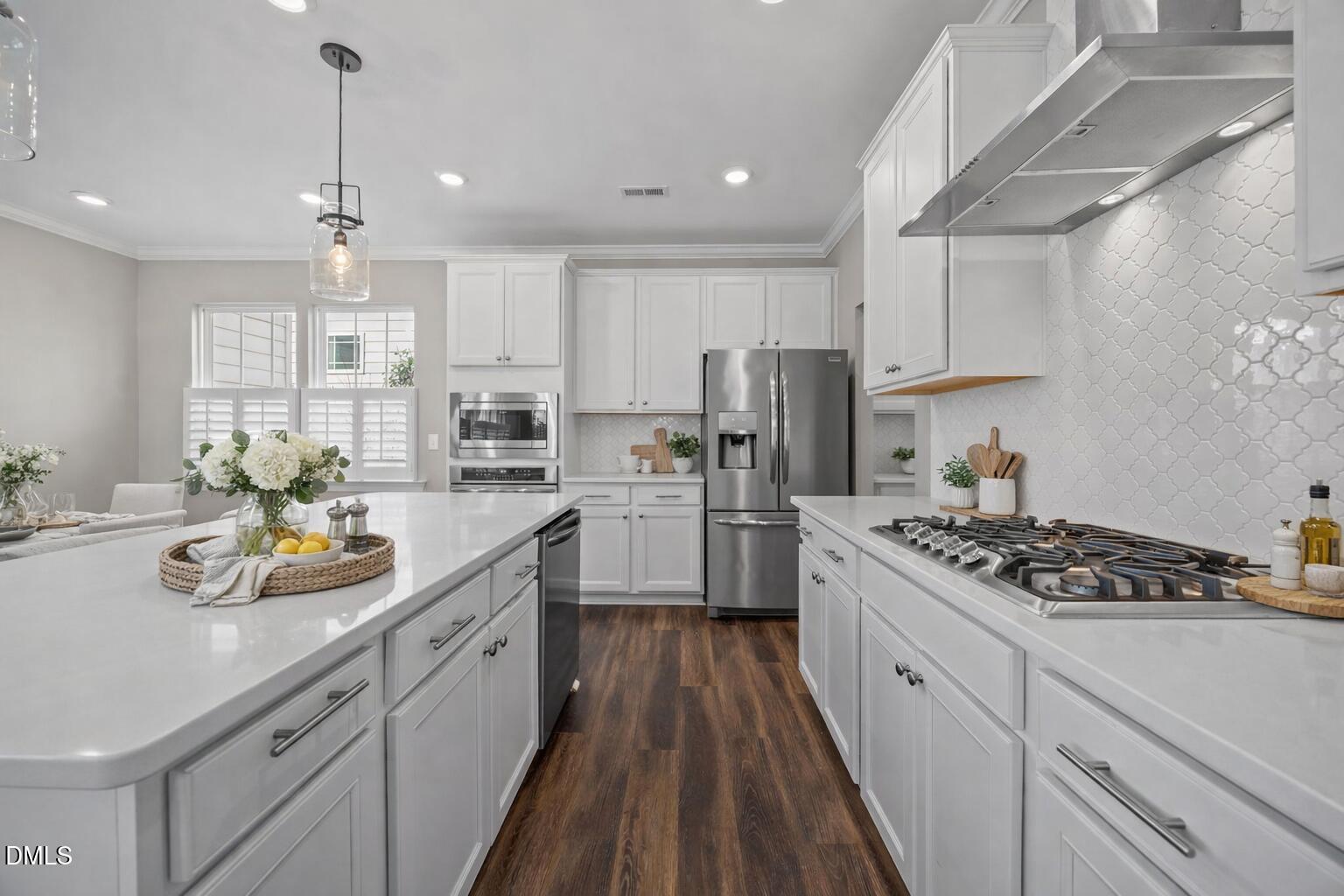 217 Masden Road Holly Springs, NC 27540 - Photo 9 of 32 a kitchen with stainless steel appliances kitchen island granite countertop a sink stove and refrigerator