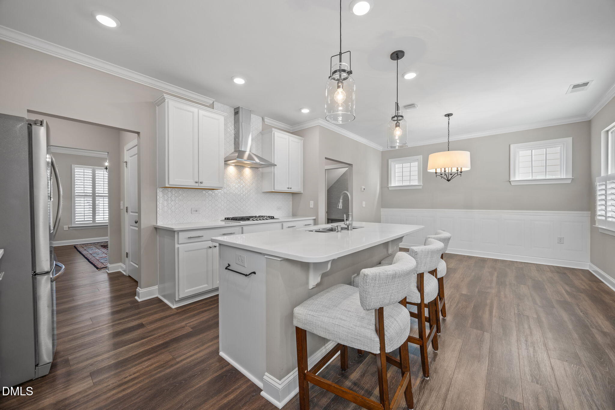 217 Masden Road Holly Springs, NC 27540 - Photo 11 of 32 a large kitchen with cabinets wooden floor white stainless steel appliances and view living room