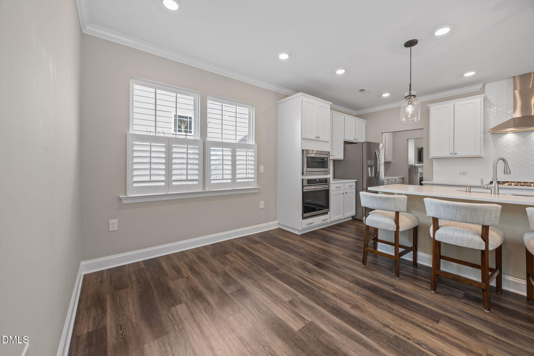 217 Masden Road Holly Springs, NC 27540 - Photo 12 of 32 a living room with stainless steel appliances kitchen island granite countertop furniture and a wooden floor