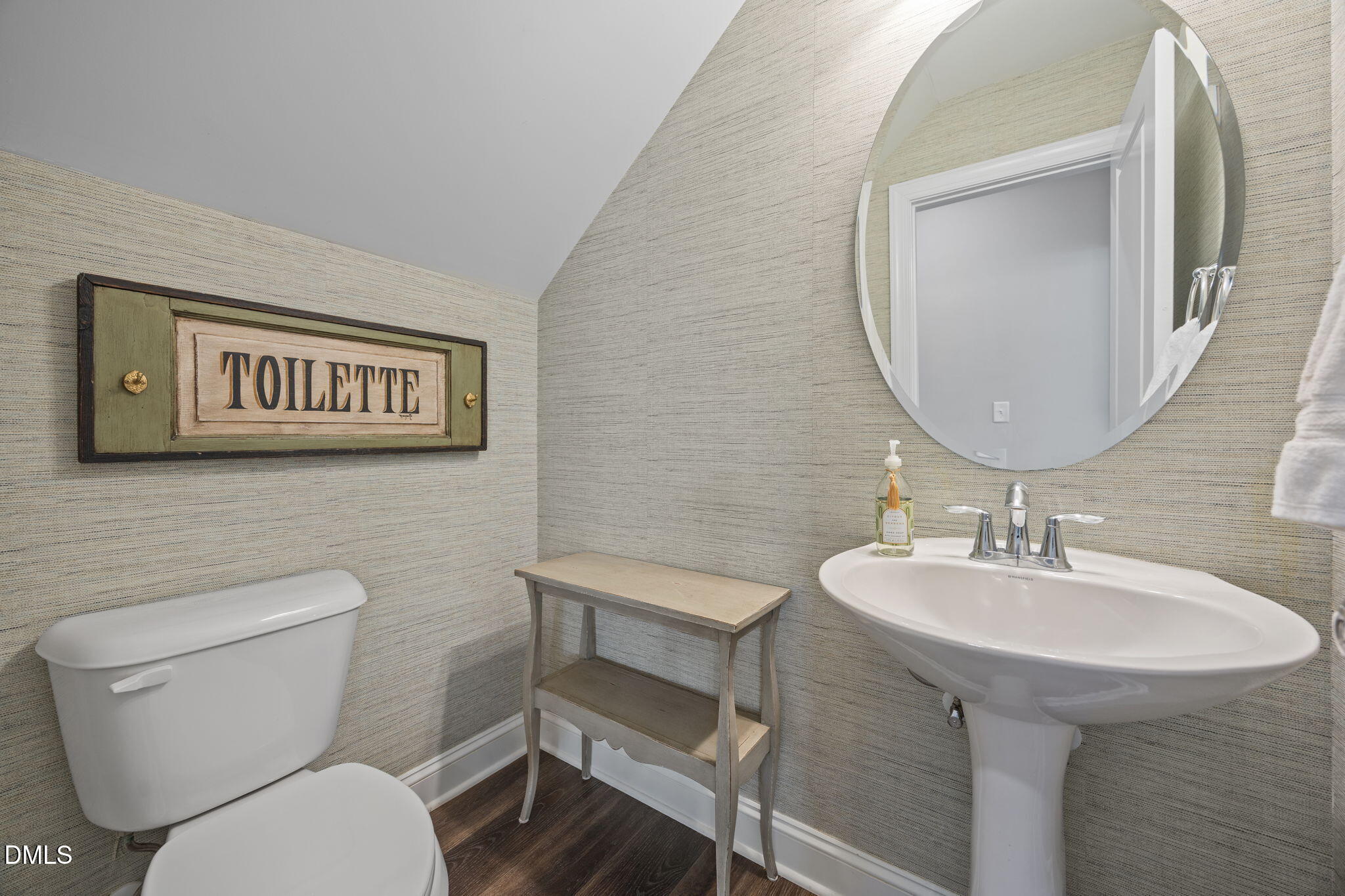 217 Masden Road Holly Springs, NC 27540 - Photo 14 of 32 a bathroom with a toilet a sink and mirror