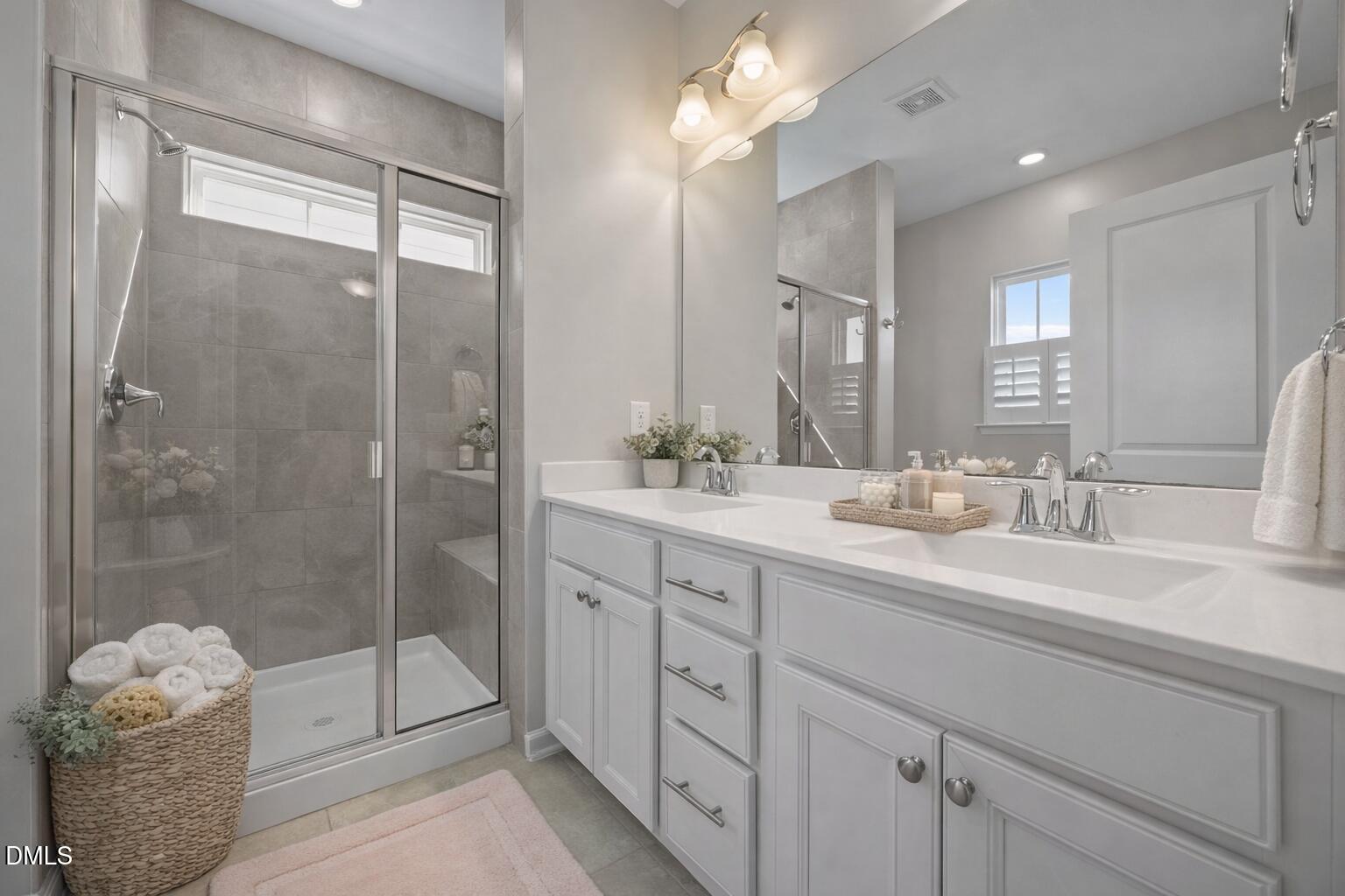 217 Masden Road Holly Springs, NC 27540 - Photo 17 of 32 a bathroom with double sink and shower