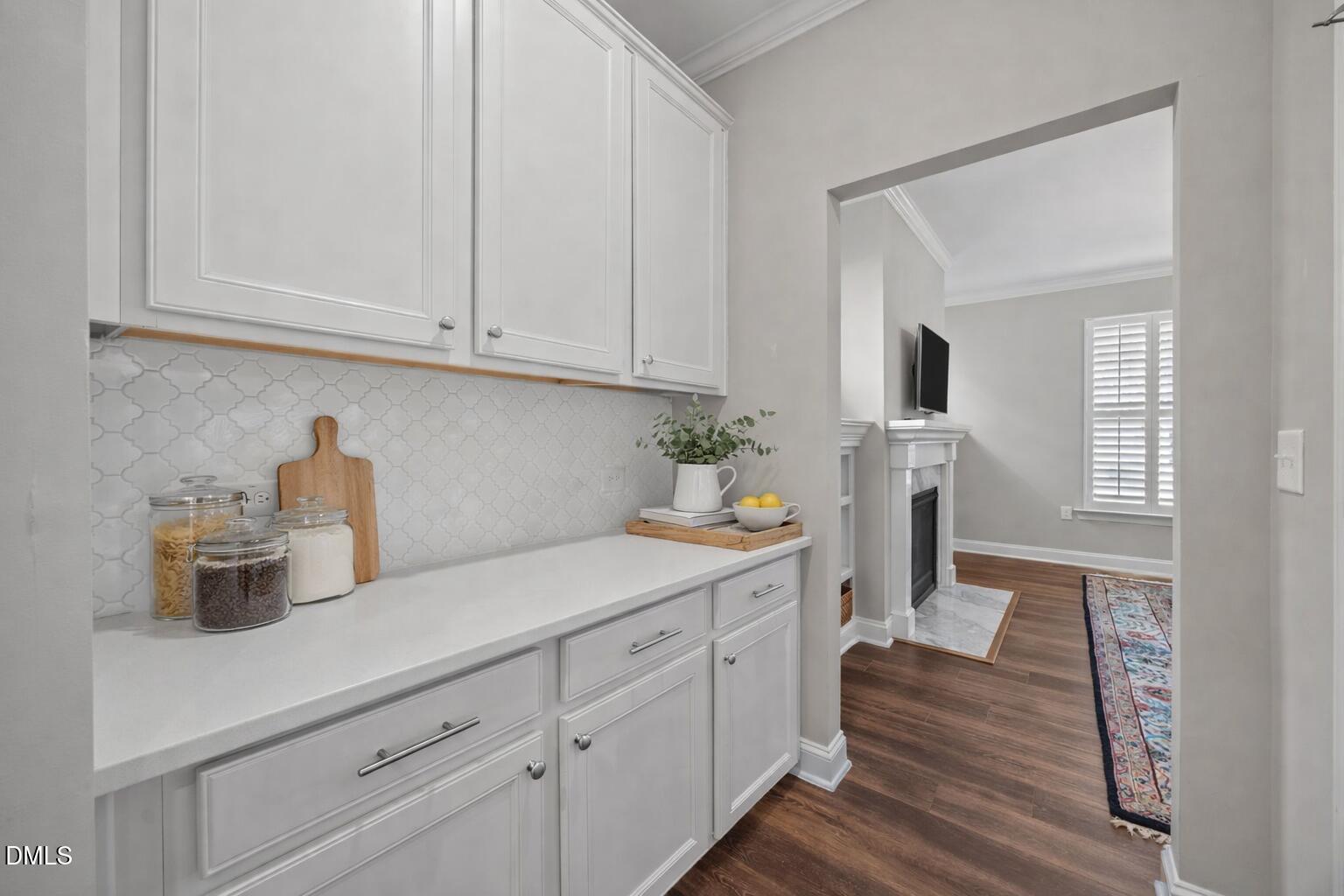 217 Masden Road Holly Springs, NC 27540 - Photo 21 of 32 a kitchen with white cabinets and sink