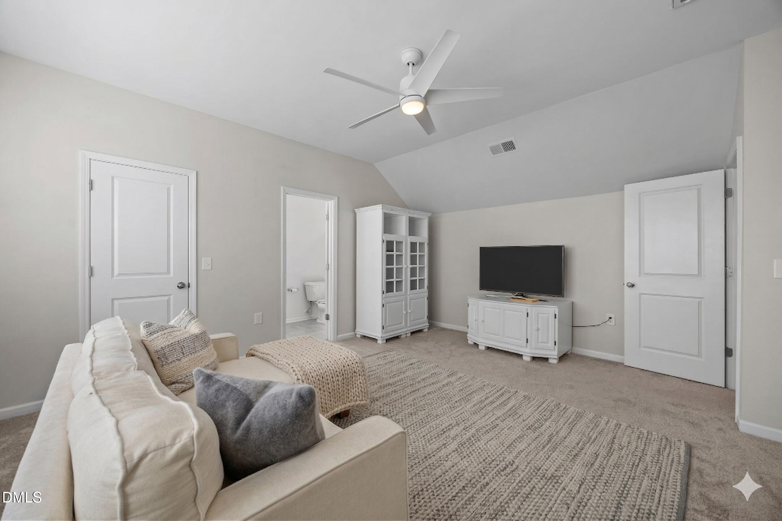 217 Masden Road Holly Springs, NC 27540 - Photo 24 of 32 a view of a livingroom with furniture and a flat screen tv
