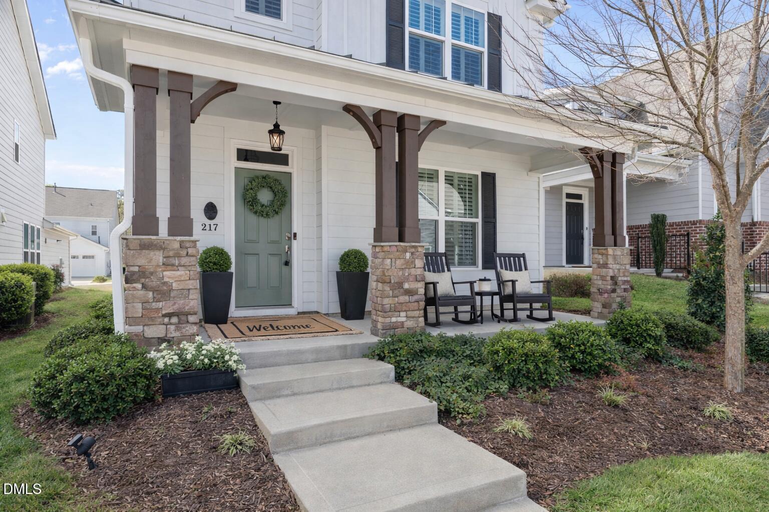 217 Masden Road Holly Springs, NC 27540 - Photo 2 of 32 a view of a house with outdoor seating area and entertaining space