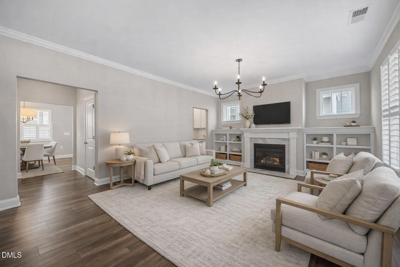 217 Masden Road Holly Springs, NC 27540 - Photo 4 of 32 a living room with furniture a fireplace and a flat screen tv